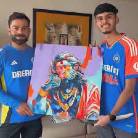 A fan paints a hand-painted image of Lord Hanuman for Virat Kohli